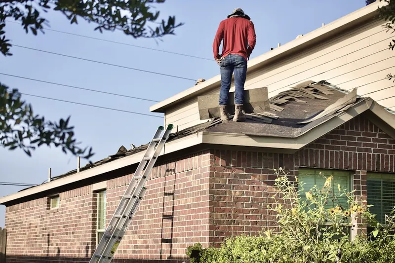 Professional roofer working on a residential roof in Lynchburg